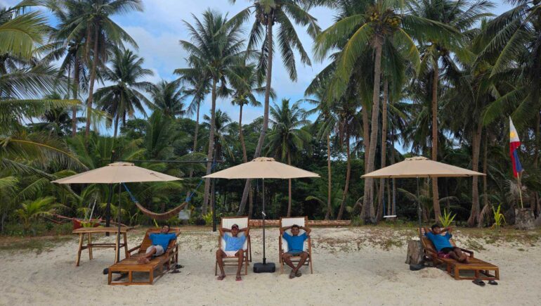 Team showing off the new umbrellas on the beach